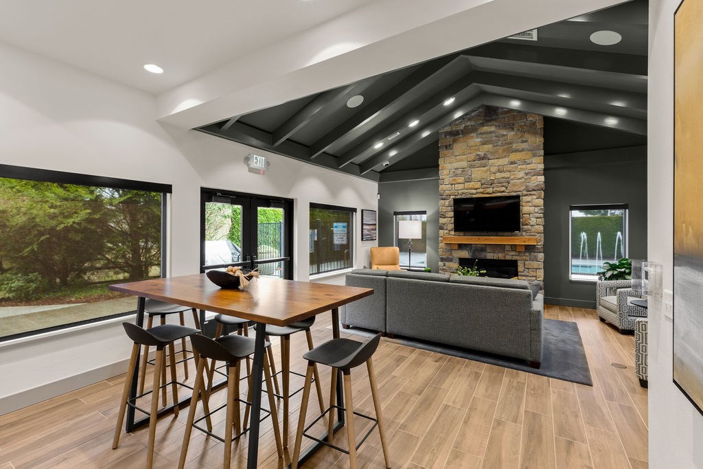 A modern dining room with a wooden table and chairs.