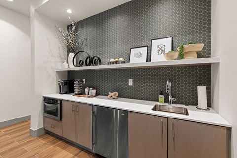 A modern kitchen with a stainless steel dishwasher and wooden cabinets.