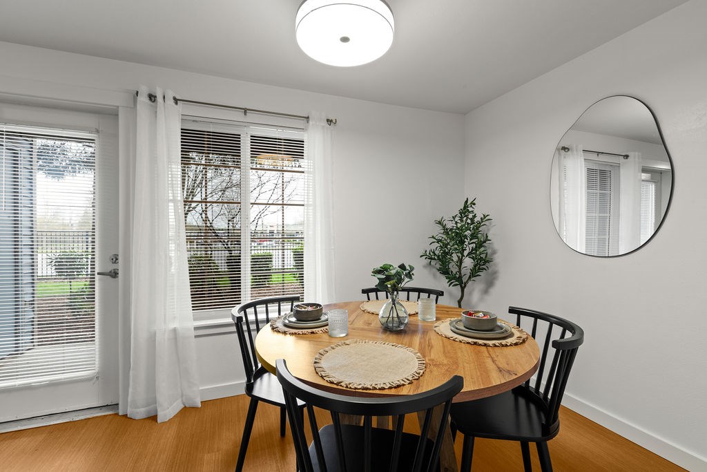 A dining room with a round table set for two.