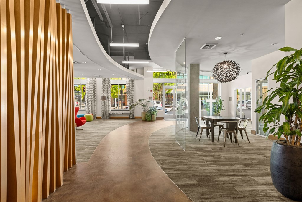 a dining area with a table and chairs in a lobby