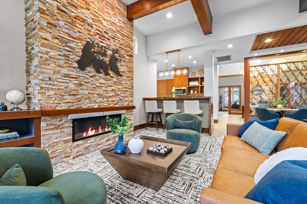 a living room with a couch and chairs and a fireplace