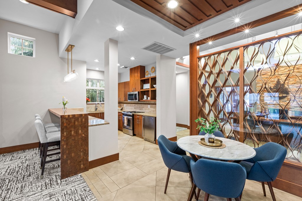 a dining room and kitchen with a table and chairs