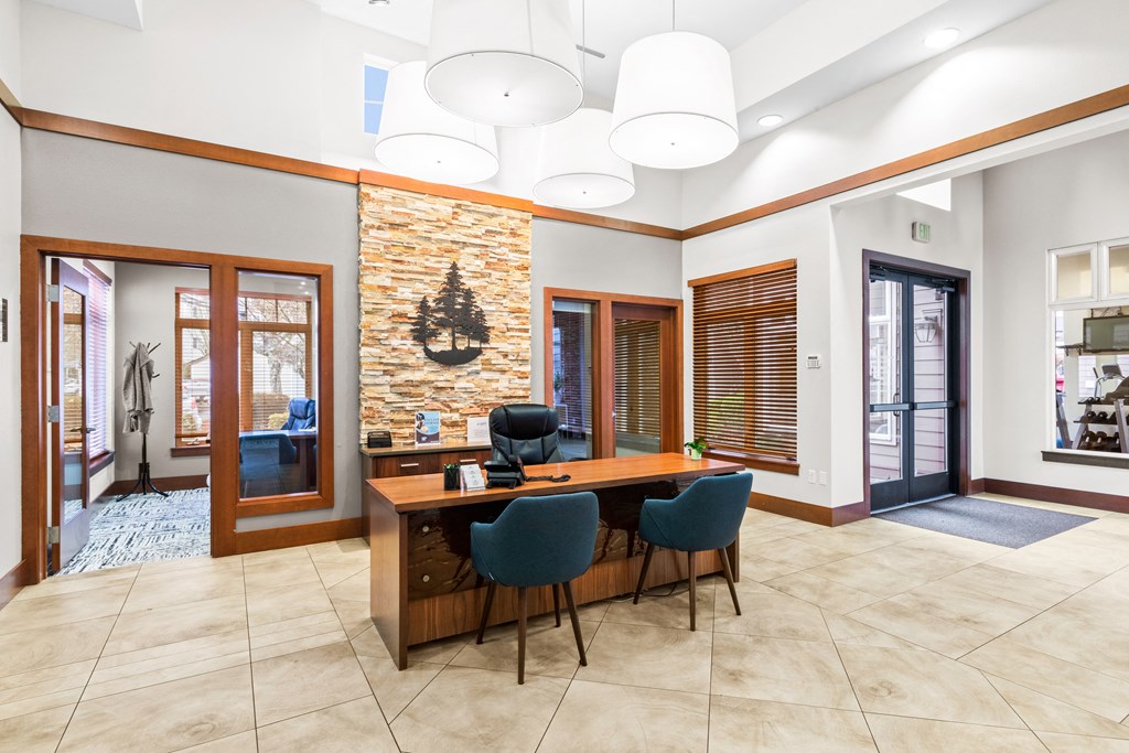 a conference room with a wooden desk and chairs and a brick wall