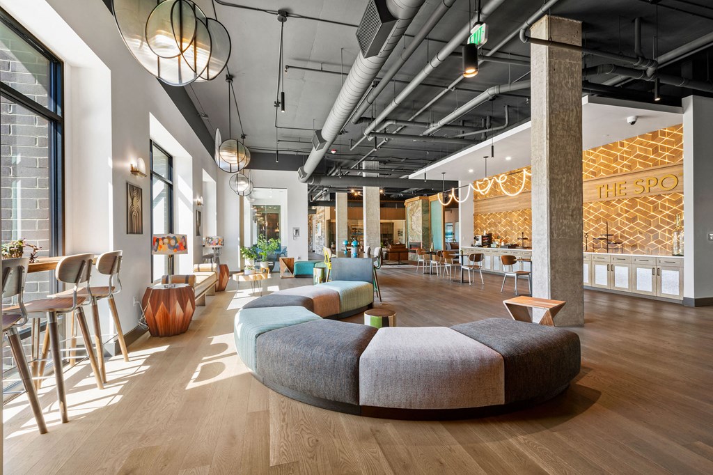 a rendering of a lobby with couches and tables