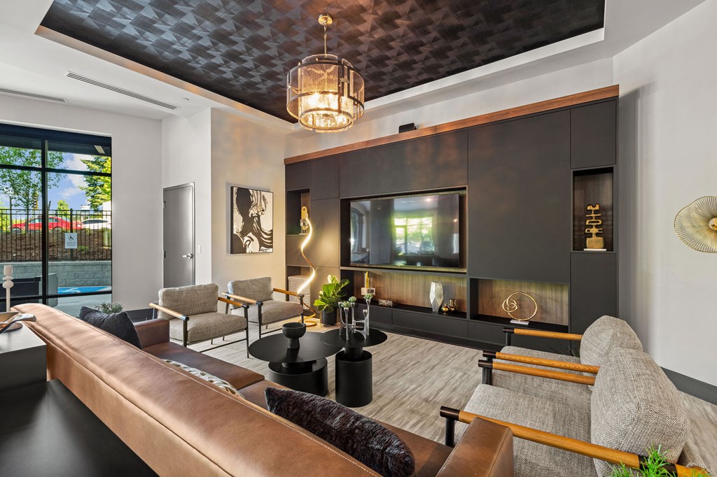 a living room with a leather couch and a television