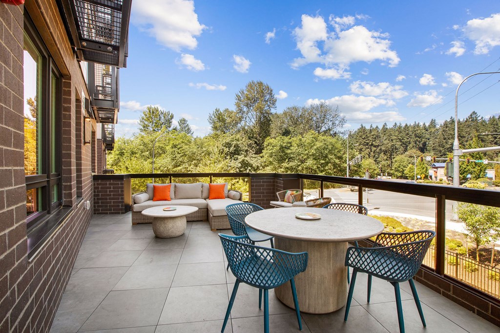 a patio with a table and chairs on a balcony
