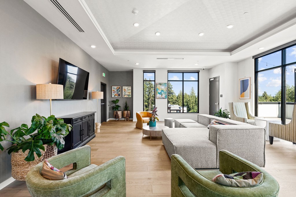 a living room with couches and chairs and a television