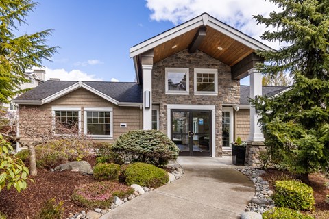 a home with a walkway leading to the front door