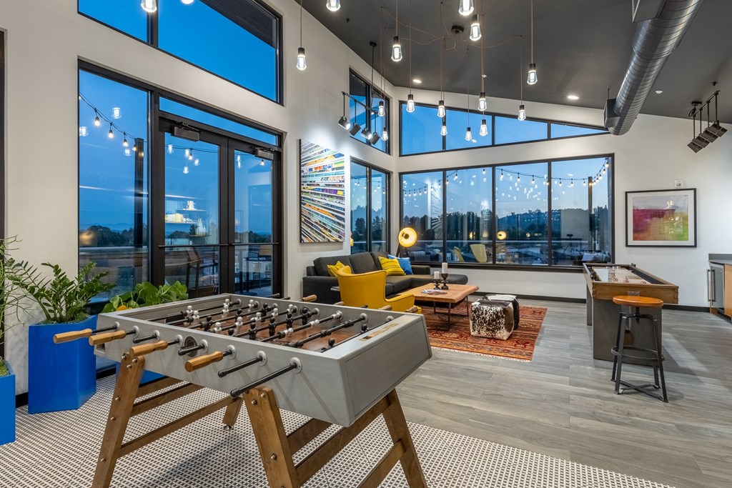 a foosball table in a living room with a view of the city
