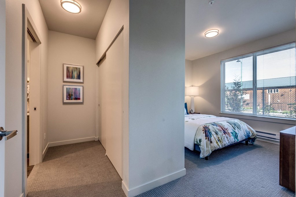 a bedroom with a bed and a large window