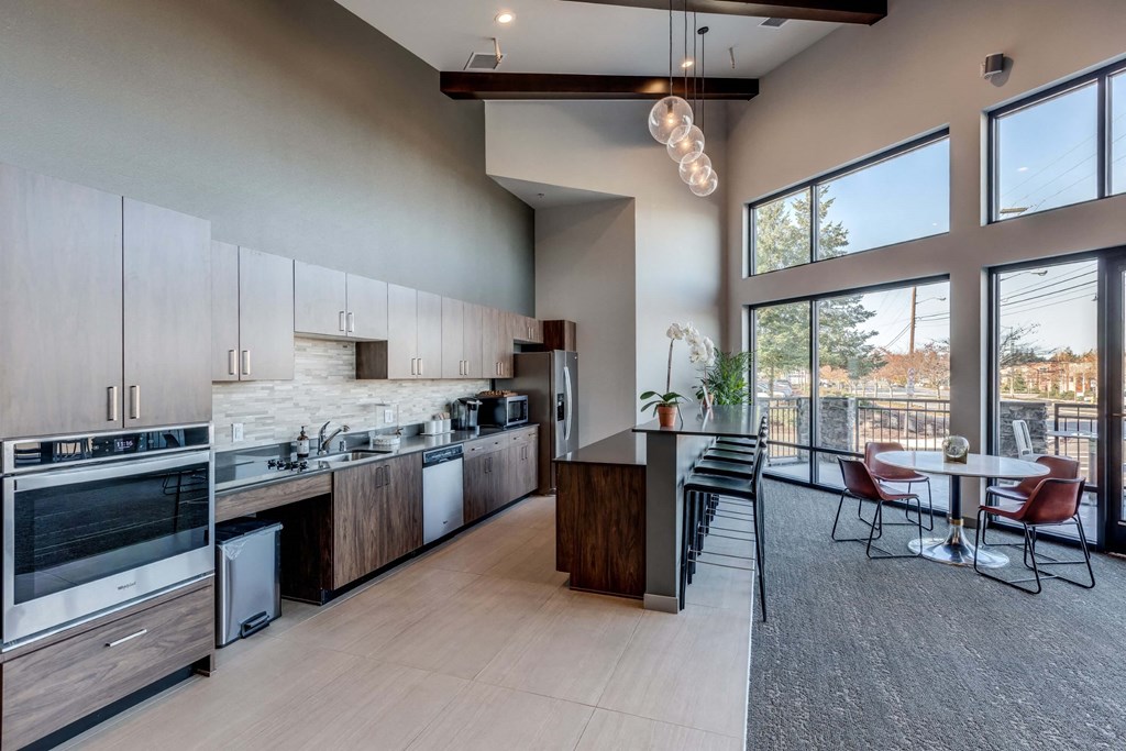 a kitchen with stainless steel appliances and a table with chairs