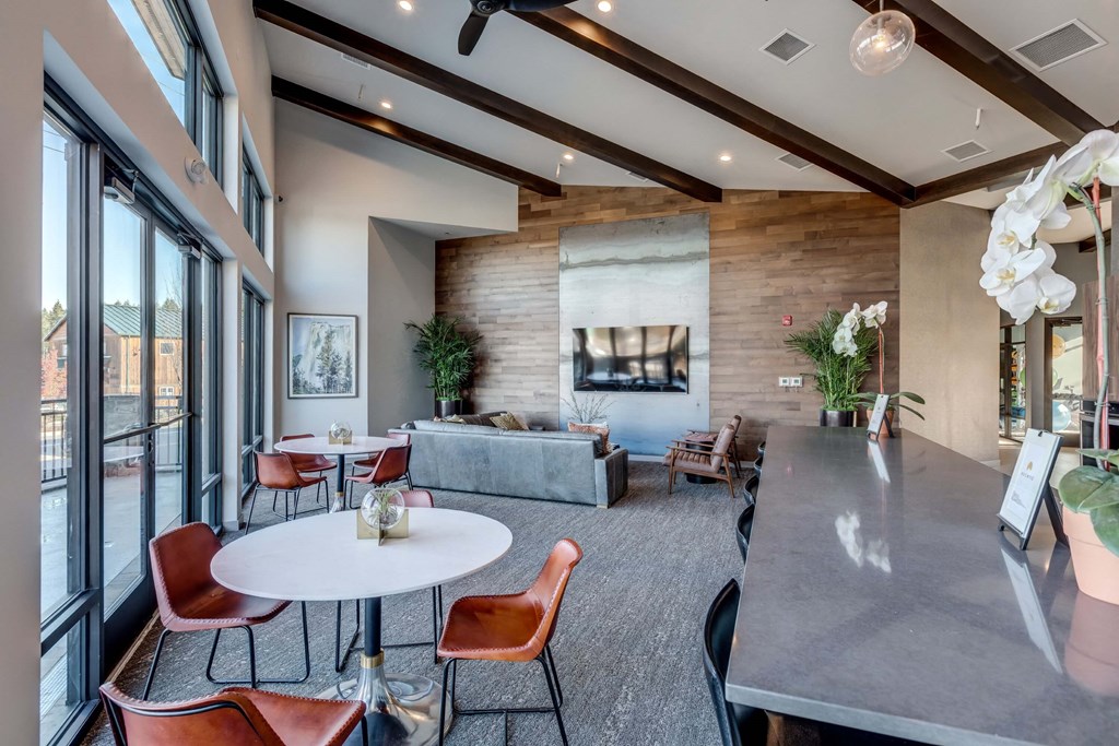 a living room with a fireplace and a table with chairs