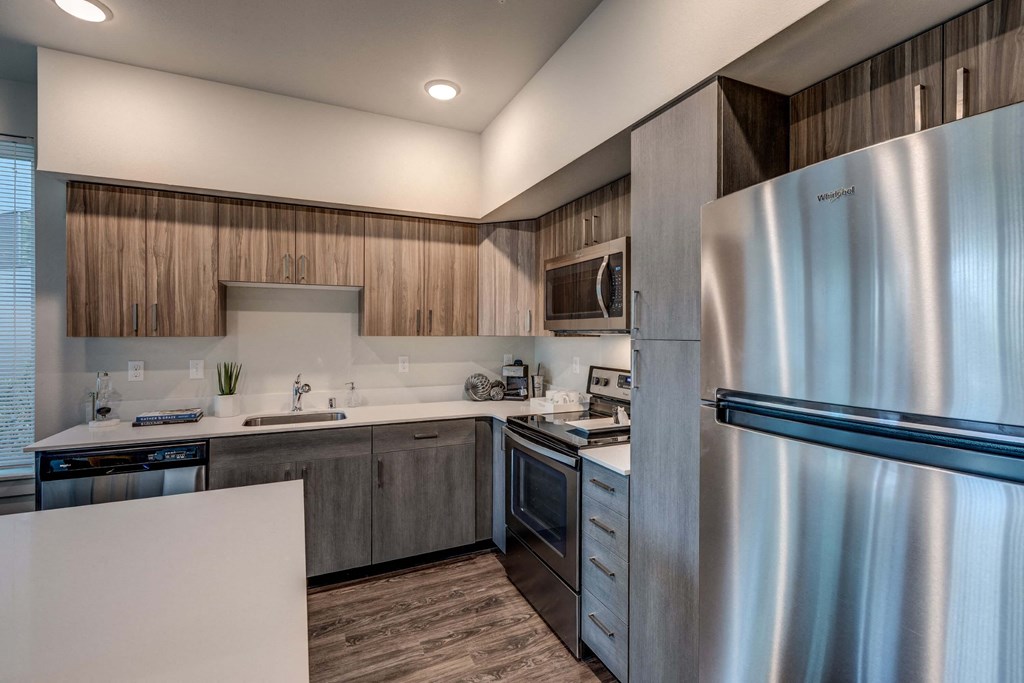 a kitchen with stainless steel appliances and wooden cabinets