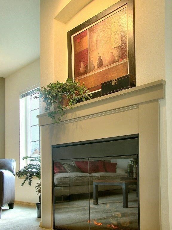 a living room with a fireplace and a painting on the wall