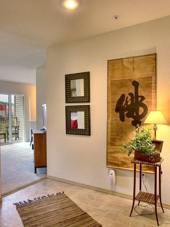 a living room with a painting on the wall