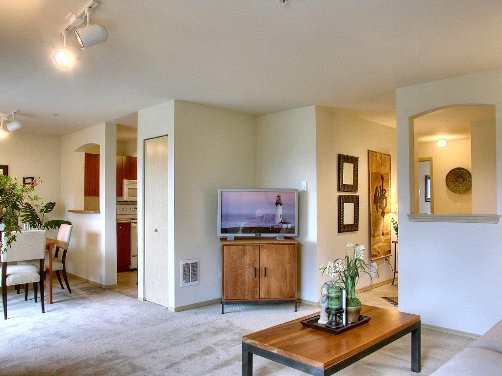 a living room and dining room with a television