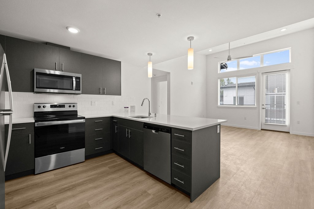 a renovated kitchen with black cabinets and a white counter top