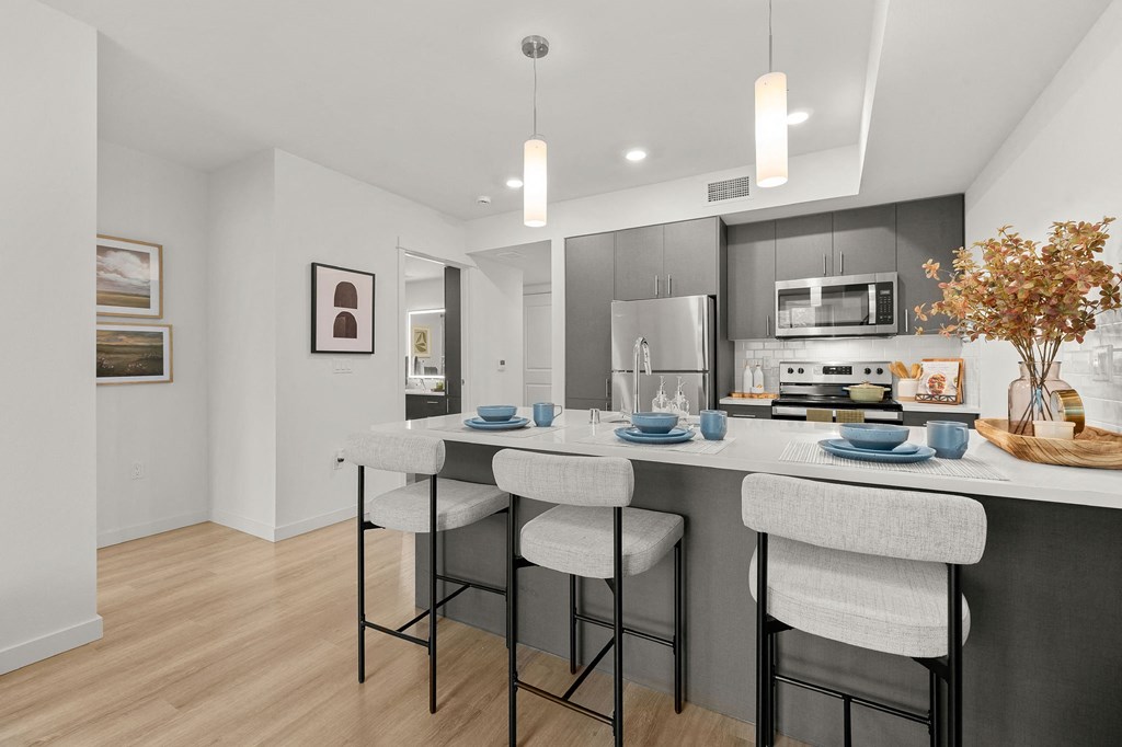a kitchen with a large island with three stools