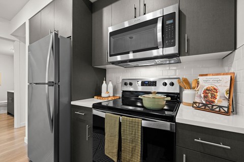 a kitchen with stainless steel appliances and a microwave