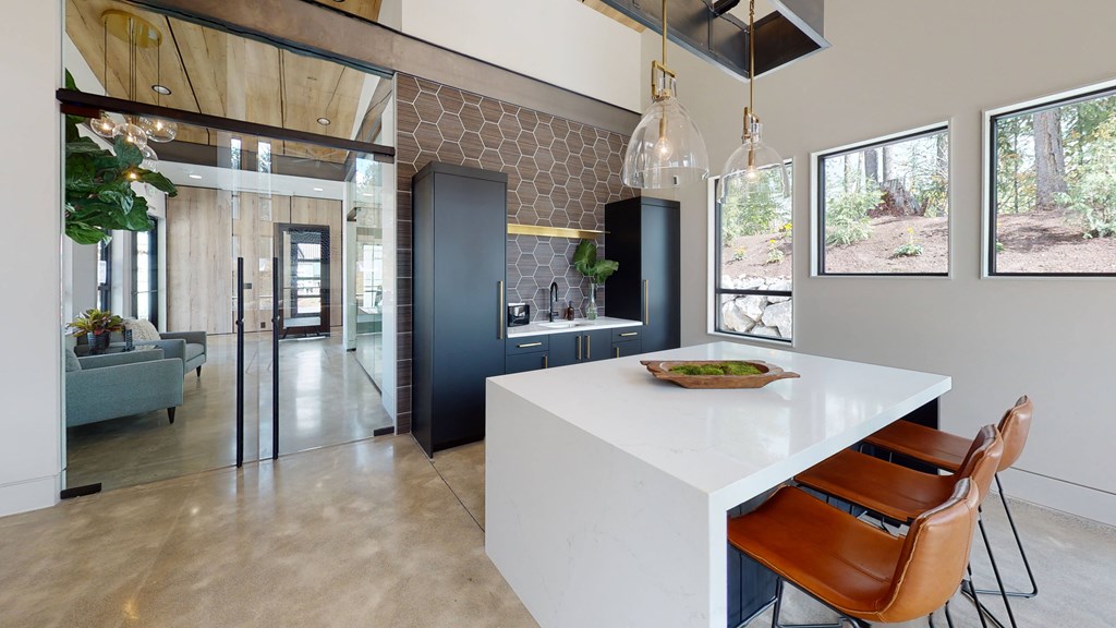 a kitchen with a white counter and a table and chairs