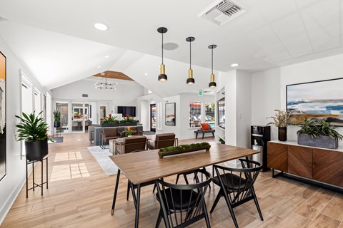 A modern dining area with a wooden table and chairs.