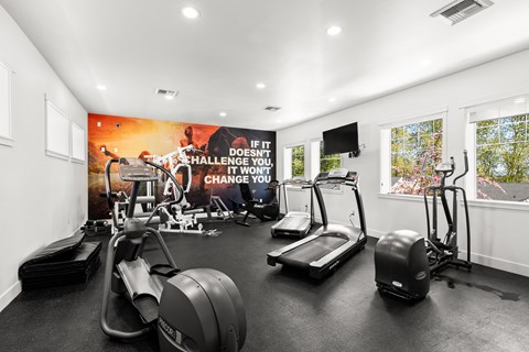 A gym with a sign that says "If it doesn't challenge you, it won't change you."