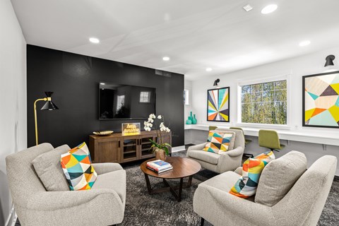 A living room with grey chairs and a coffee table.