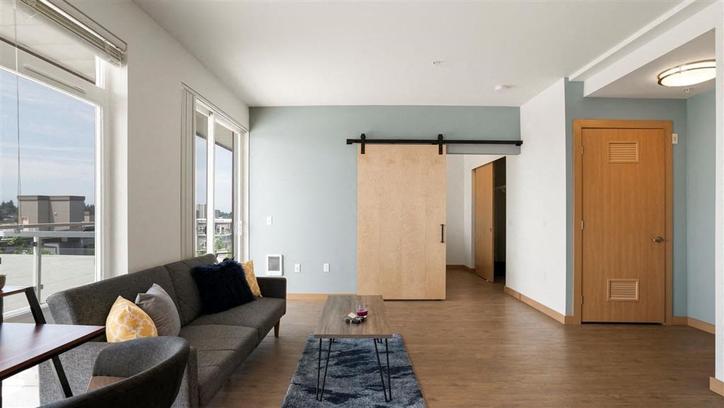 a living room with a couch and a wooden door