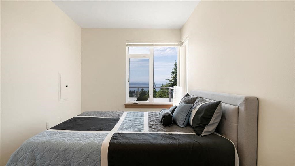 a bedroom with a large bed and a large window