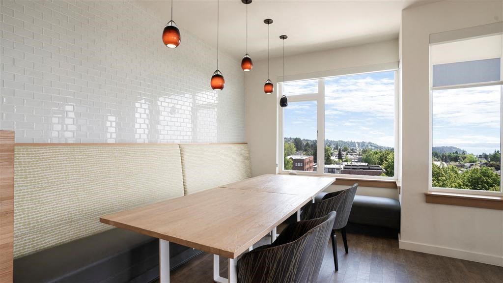 a dining room with a wooden table and chairs