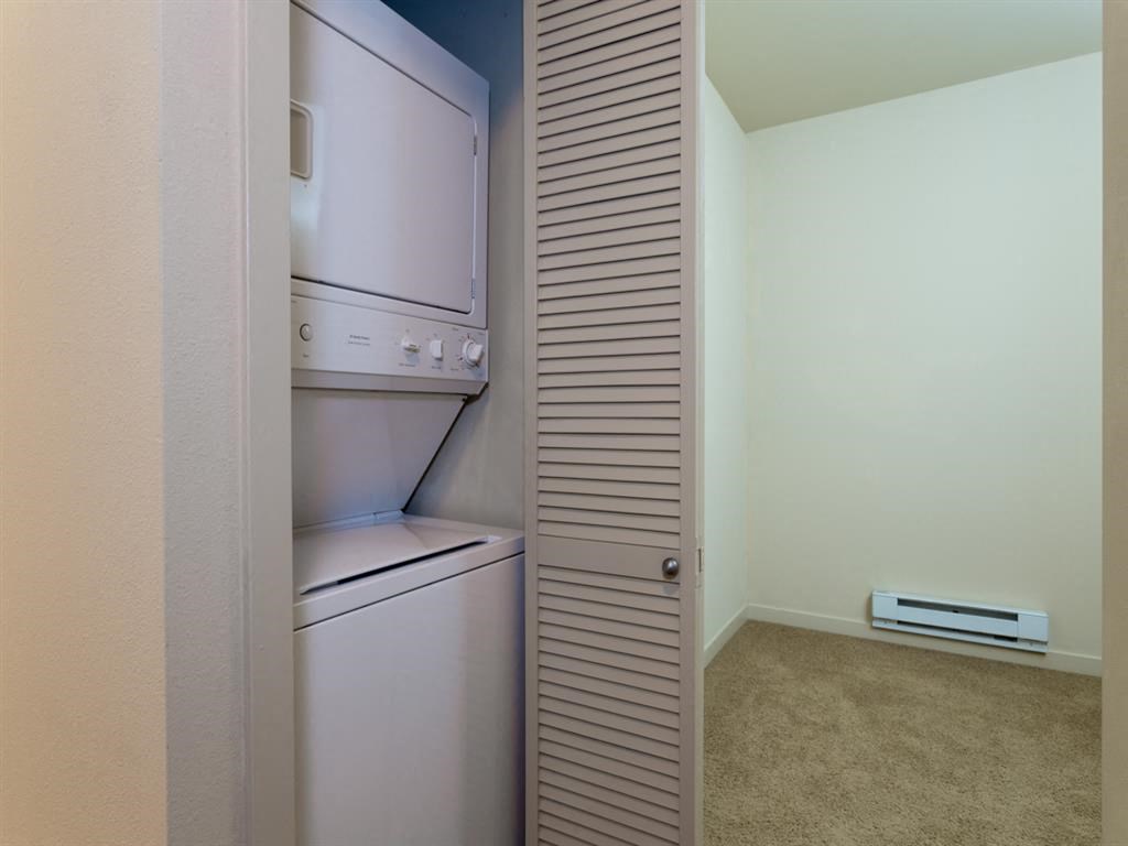 a closet with a washer and dryer in a room