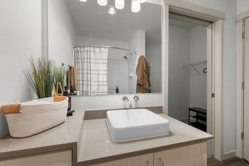 a white bathroom with a sink and a mirror