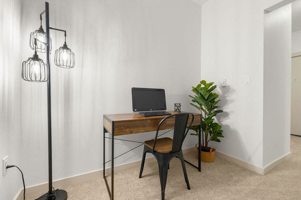 a home office with a laptop computer on a desk