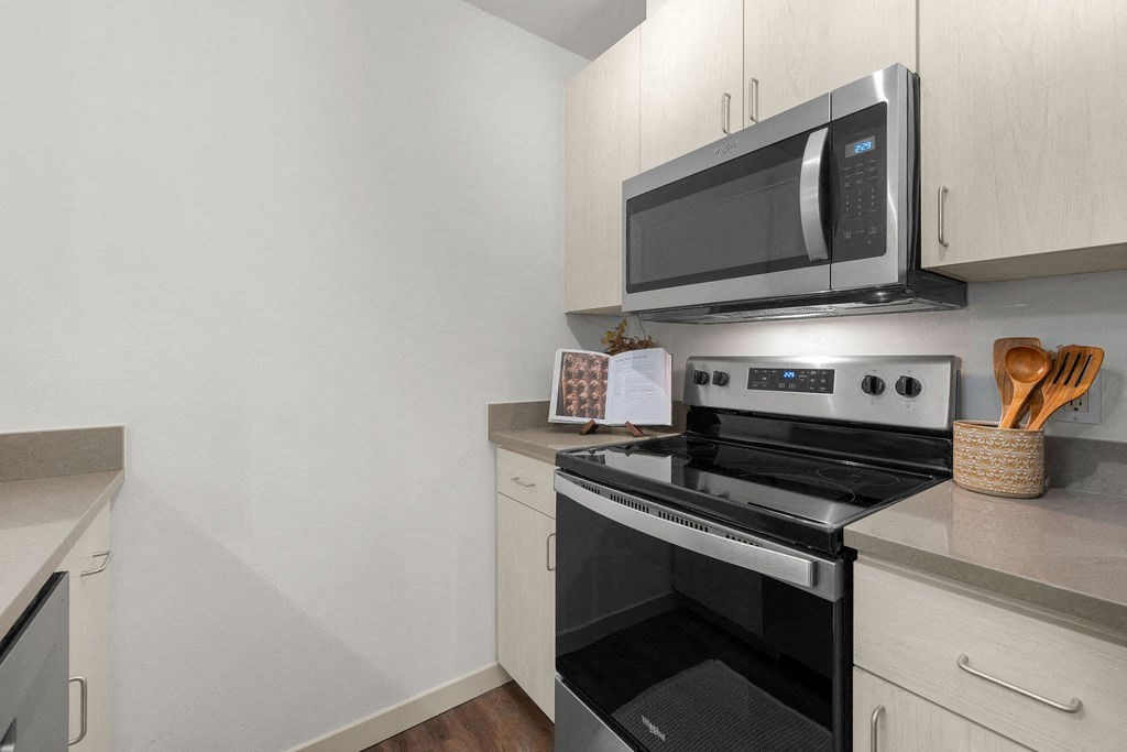 a kitchen with a stove and a microwave