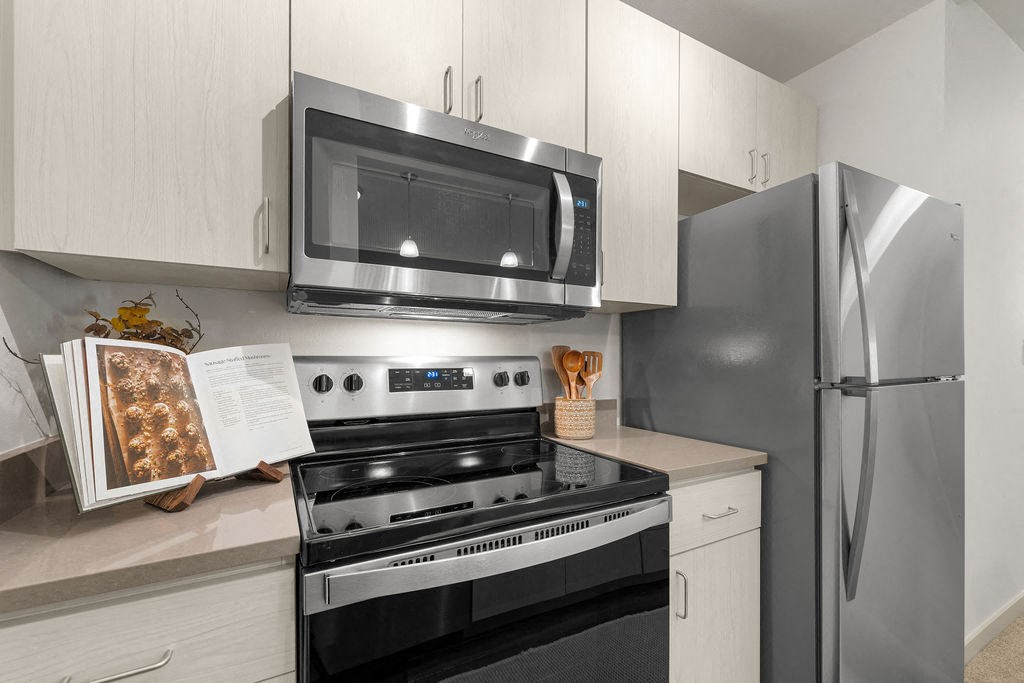 a kitchen with stainless steel appliances and white cabinets