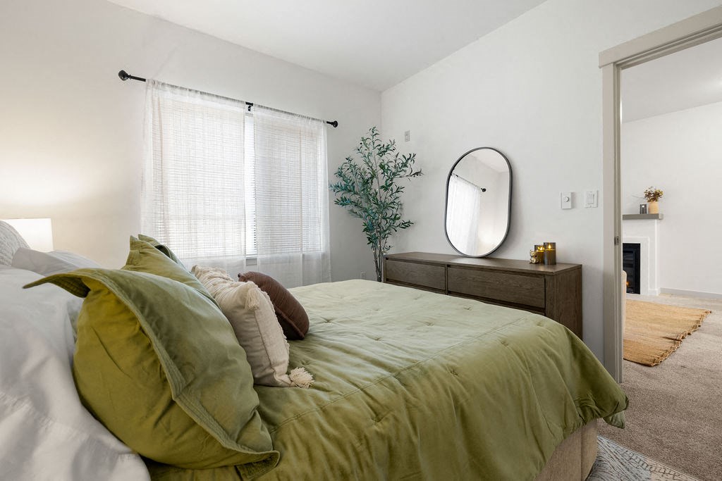 a bedroom with a bed and a mirror