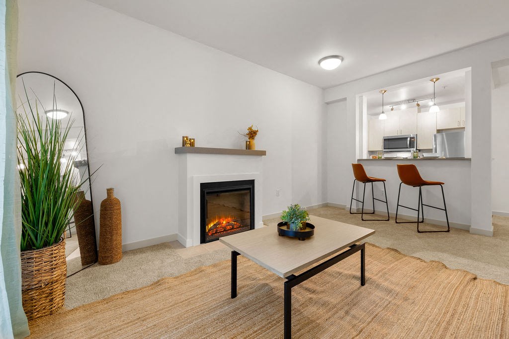 a living room with a fireplace and a table