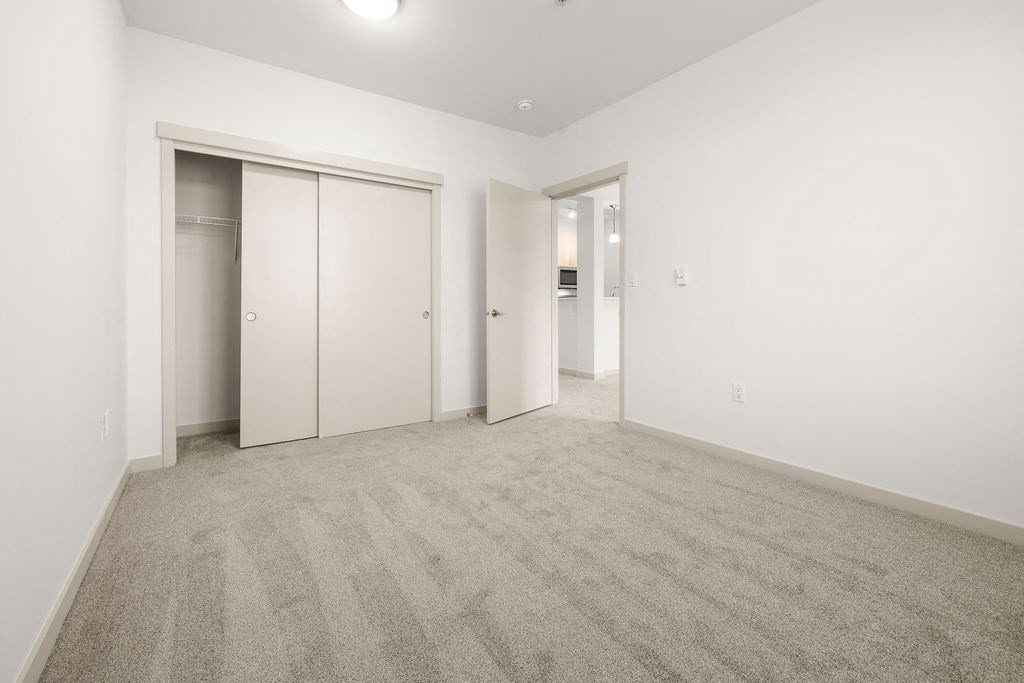 A room with carpeted floor and white walls.