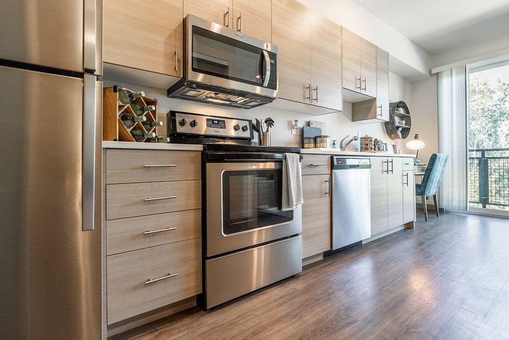 a kitchen with stainless steel appliances and a microwave