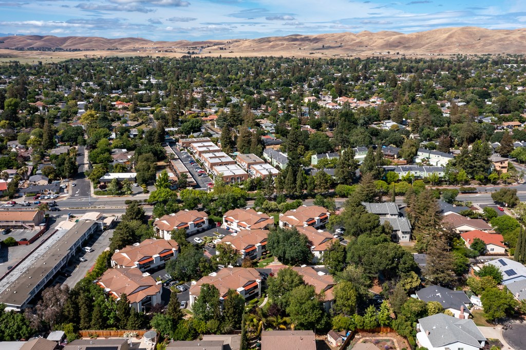 an aerial view of a neighborhood of houses with trees and mountains in the background at Greentree Terrace Apartments, CONCORD, CA, 94521