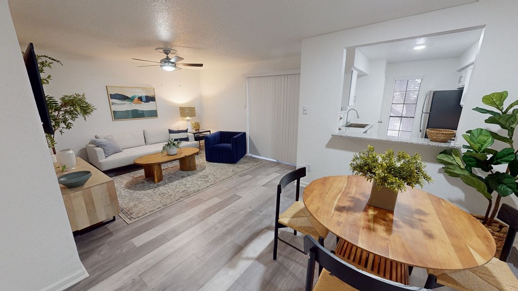 an open living room and dining room with a table and a couch