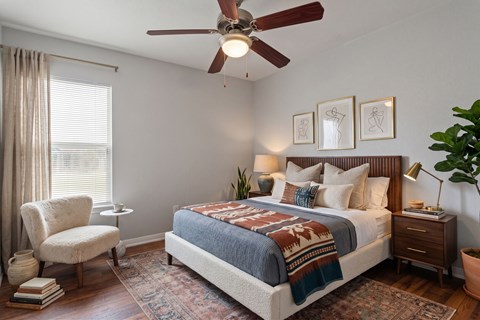 Bedroom with ceiling fan and modern furnishings at Country Park Apartments, Denton, TX