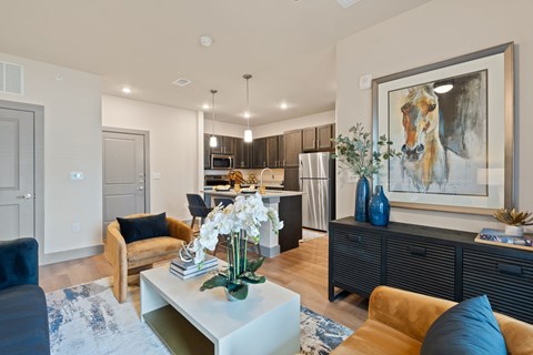 A modern living room with a large painting on the wall.