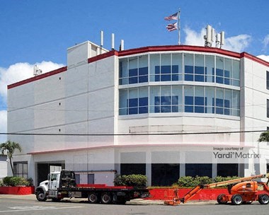 a large white building with a truck in front of it