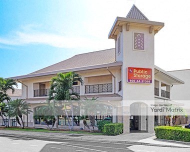 a large white building with a red sign on the side of it