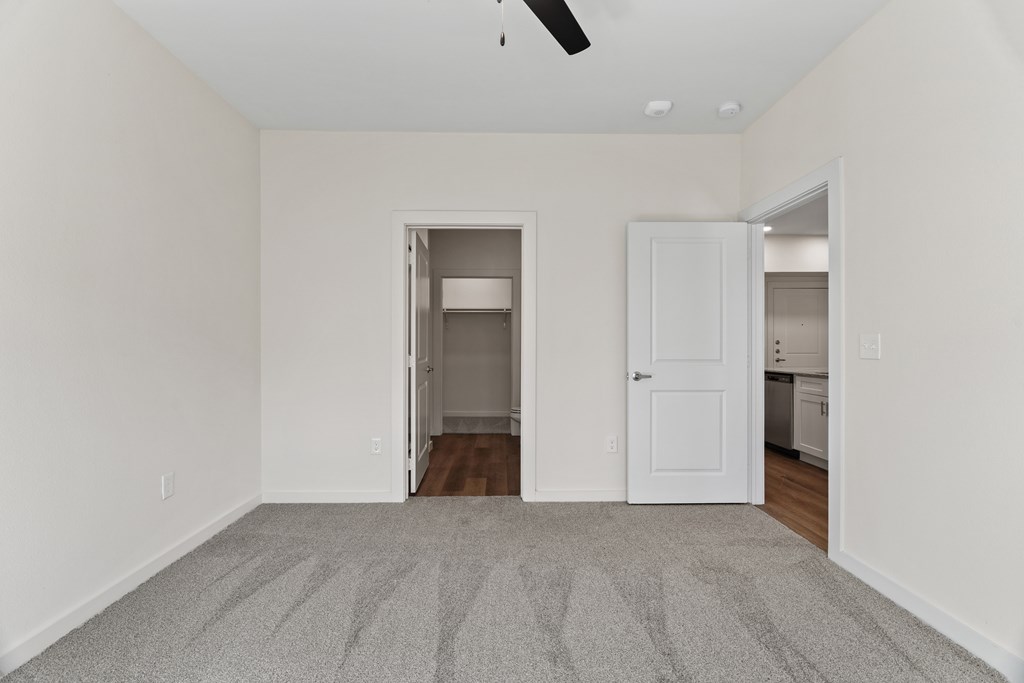 A room with a carpeted floor and a ceiling fan at SOSA at Palo Alto Apartments, Texas
