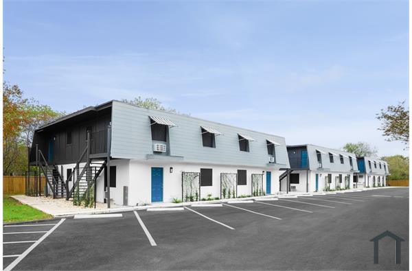 A building with a parking lot in front of it.