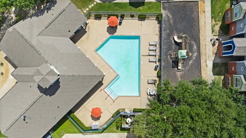 A swimming pool with a slide and a hot tub.