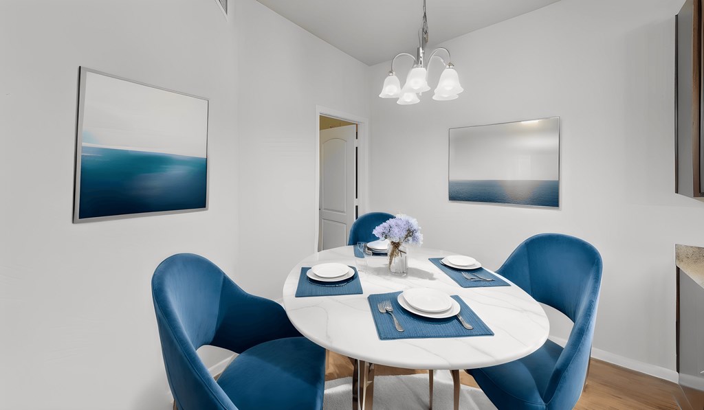 a dining room with a white table and blue chairs