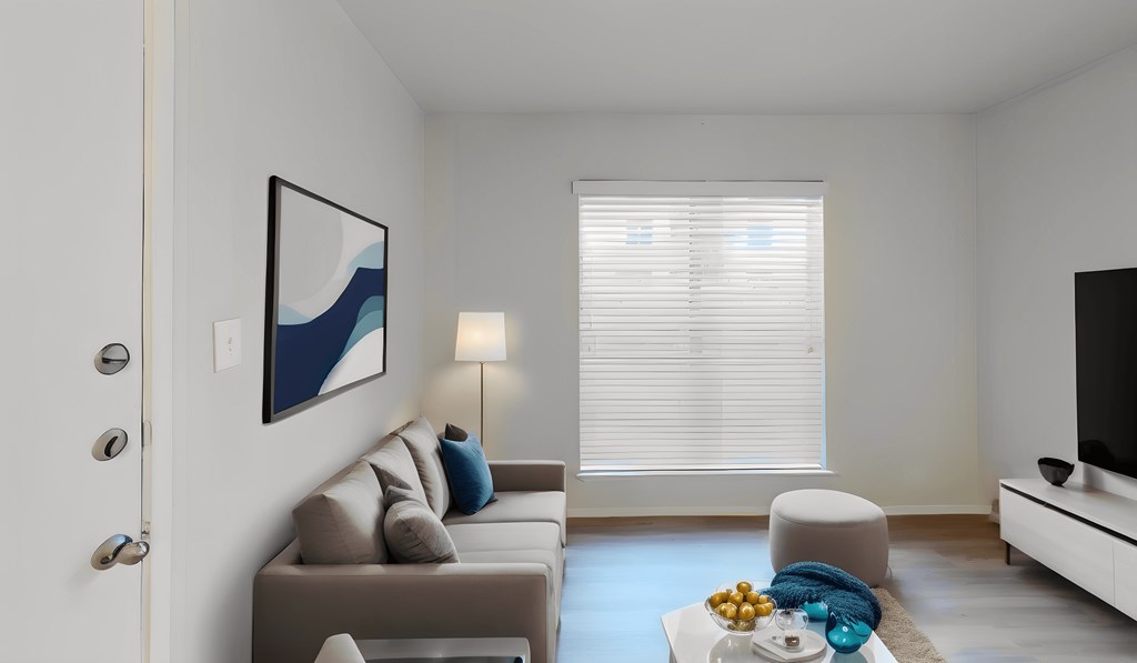 a living room with a couch and a table and a window
